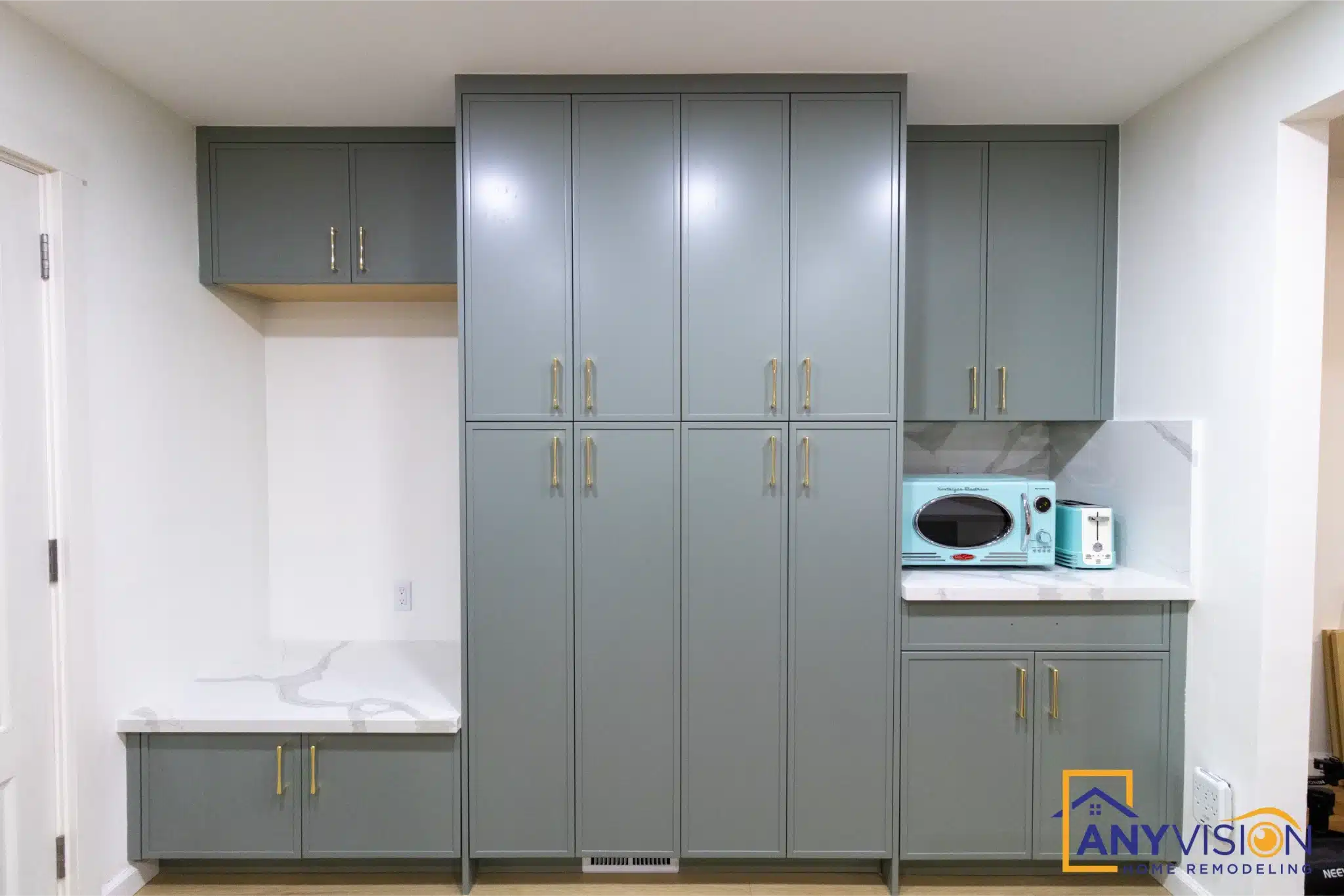 Full-height cabinet bank with integrated microwave and pull-out storage