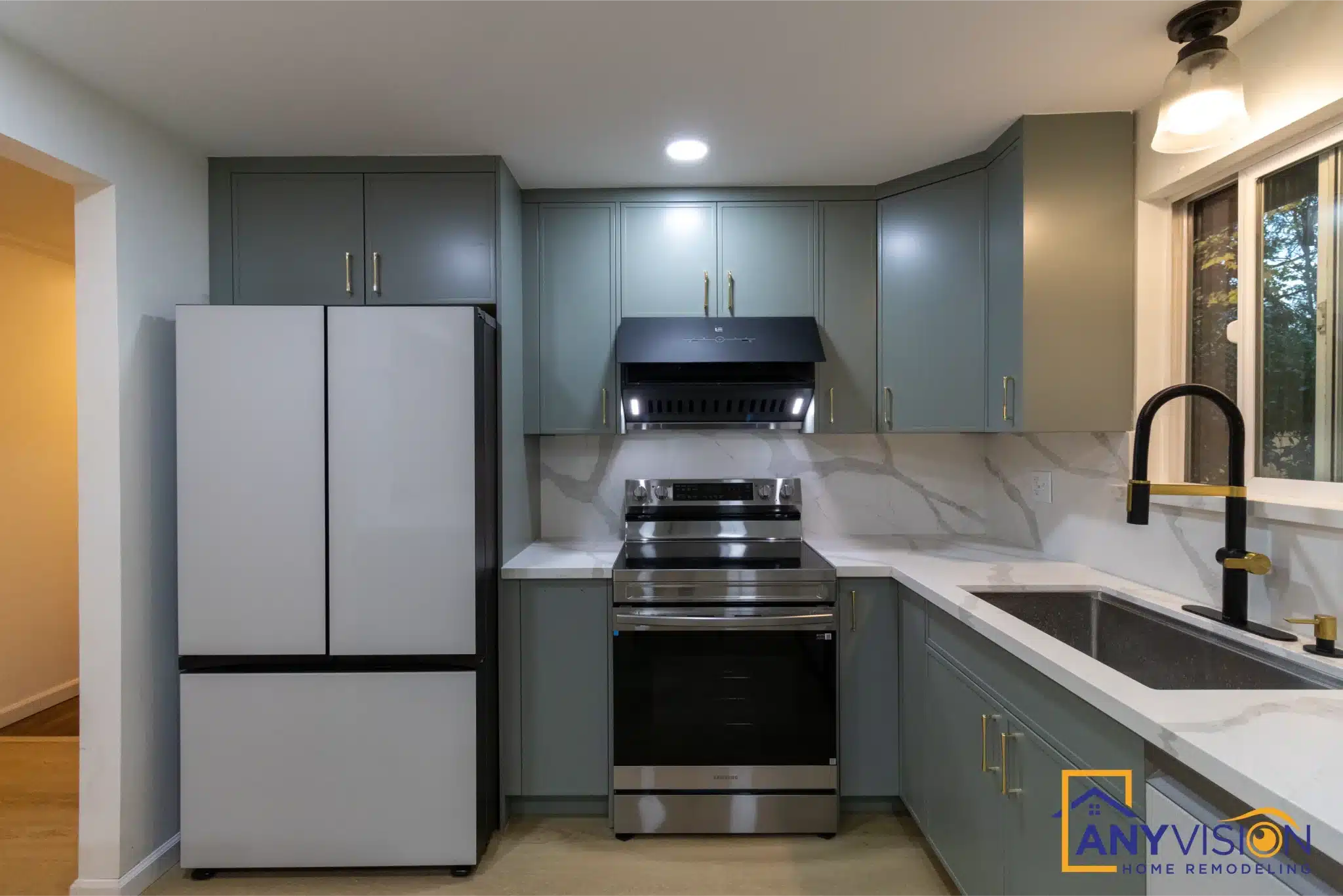 Refrigerator, range and sink set along one continuous cabinetry run