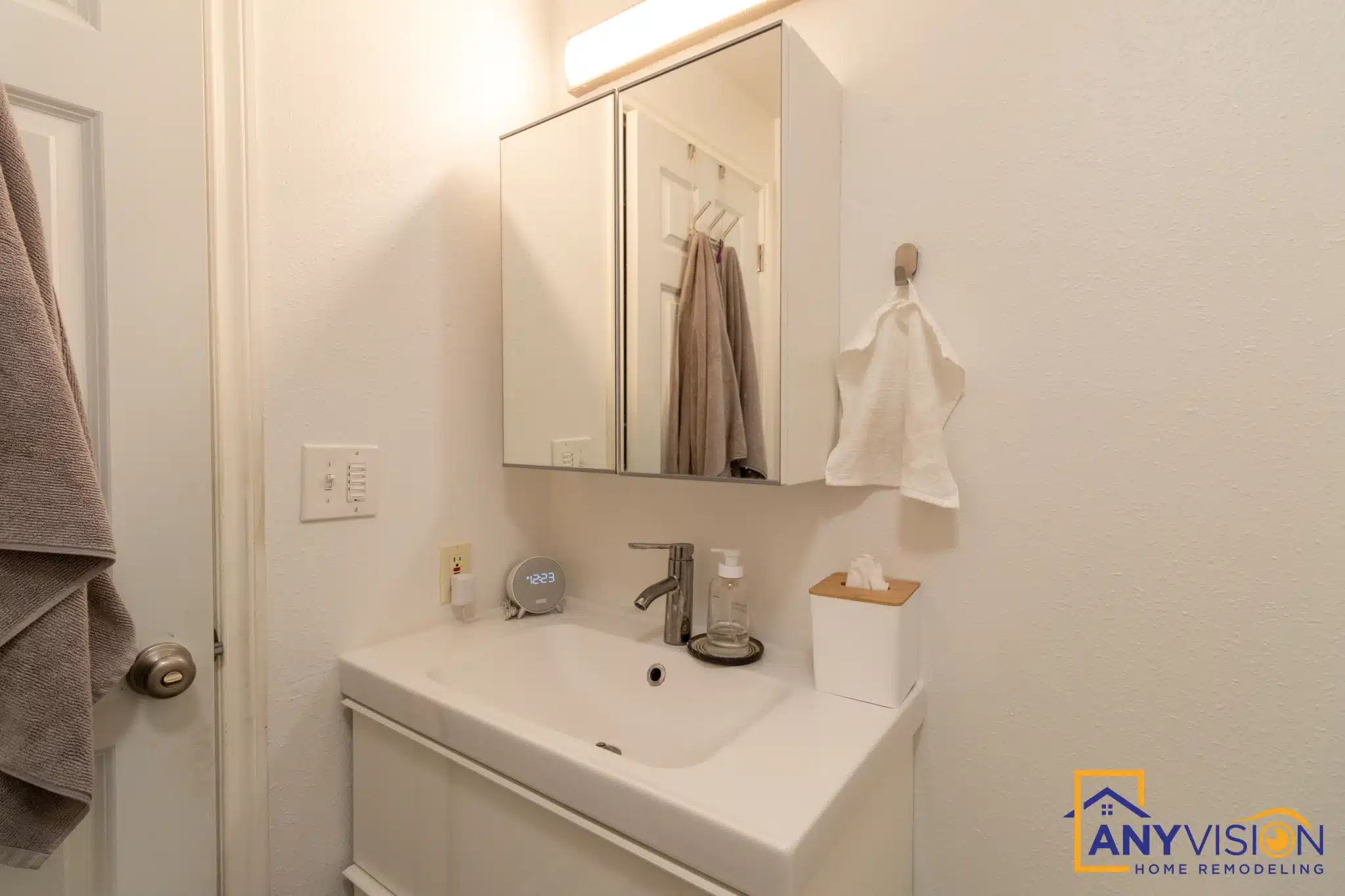 White vanity and mirror cabinet in the compact second bathroom