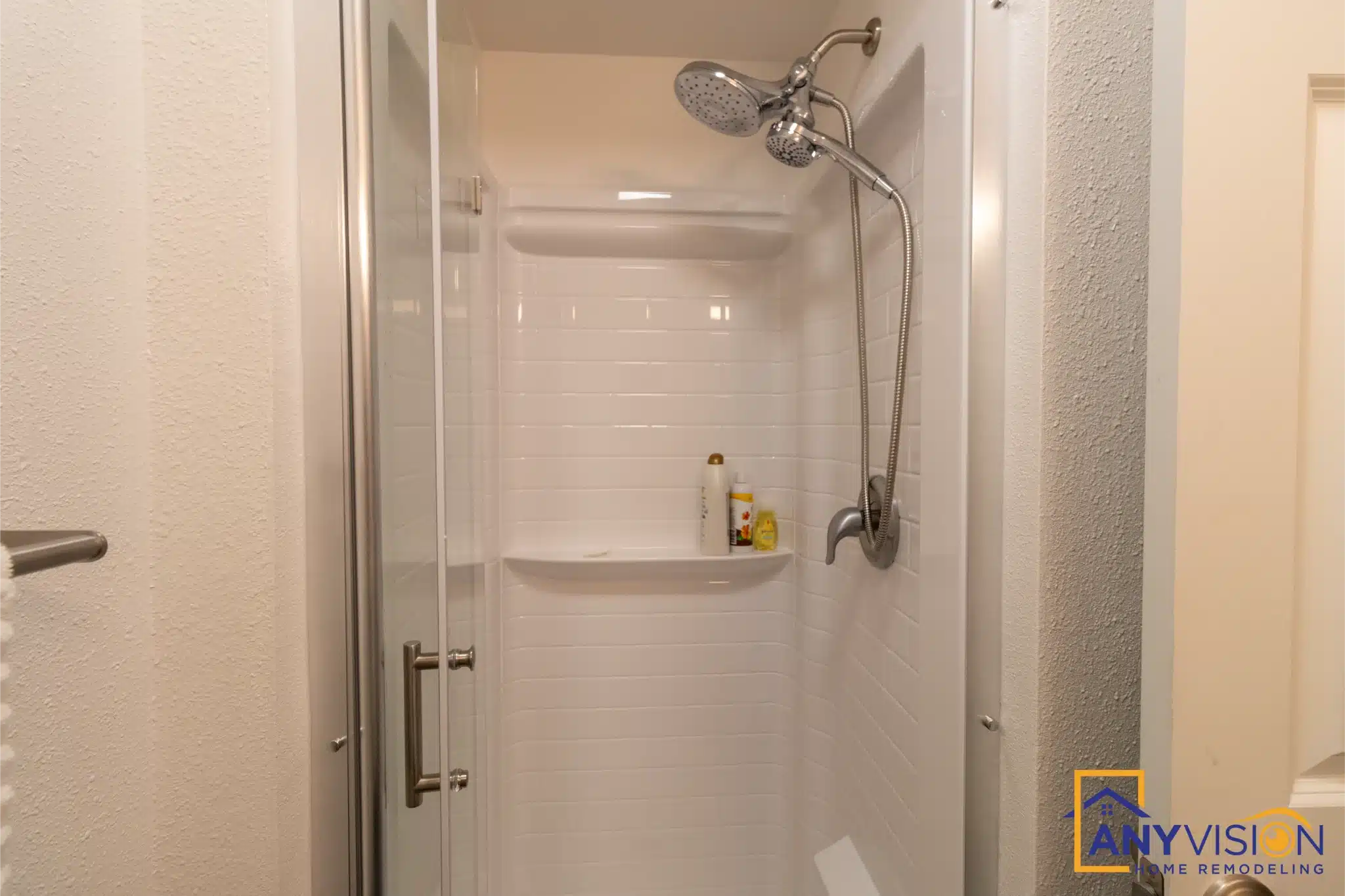 White shower surround with handheld and matte black fittings in the second bathroom