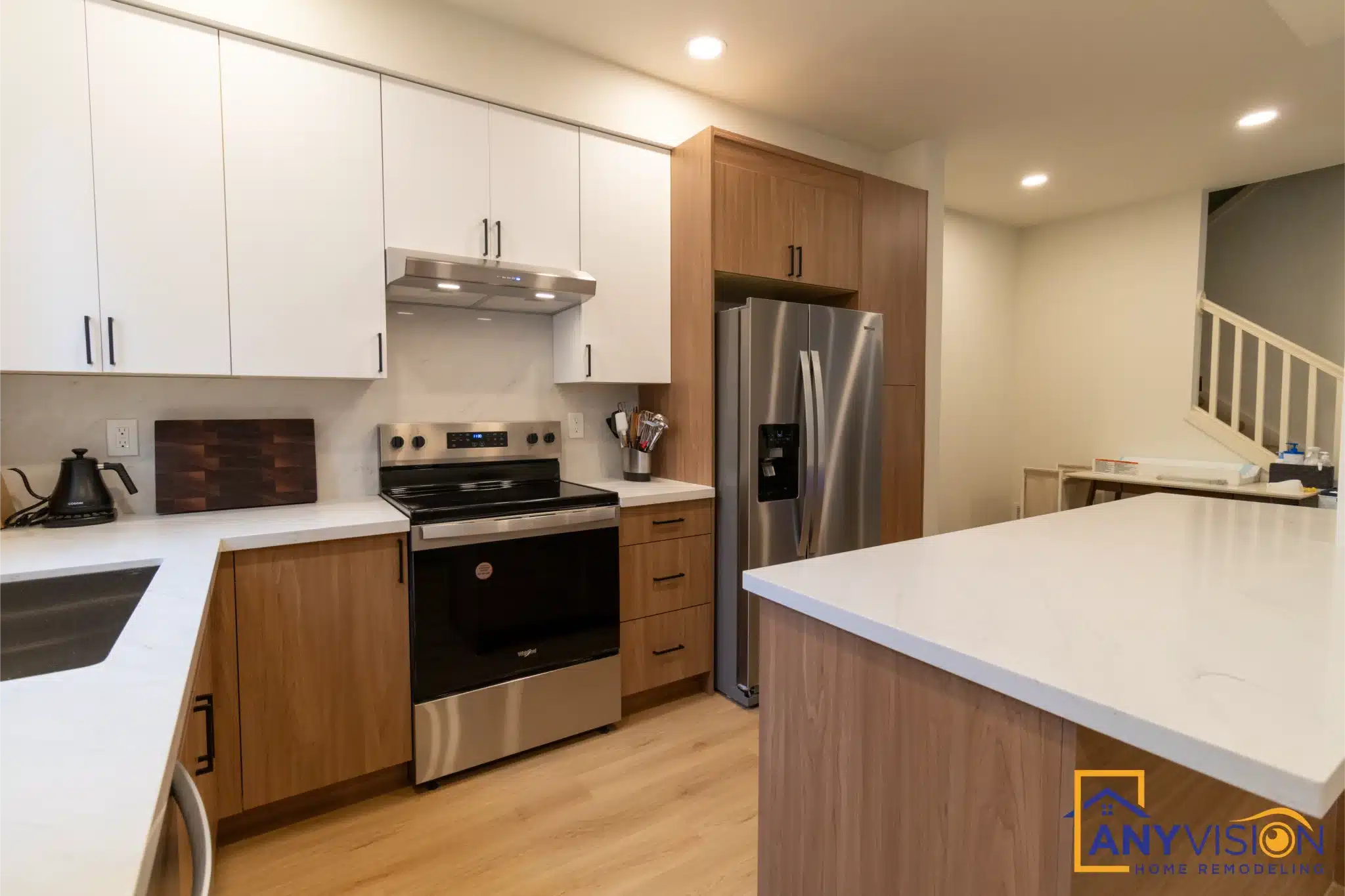 Kitchen looking toward the stairs, with the range and refrigerator run alongside