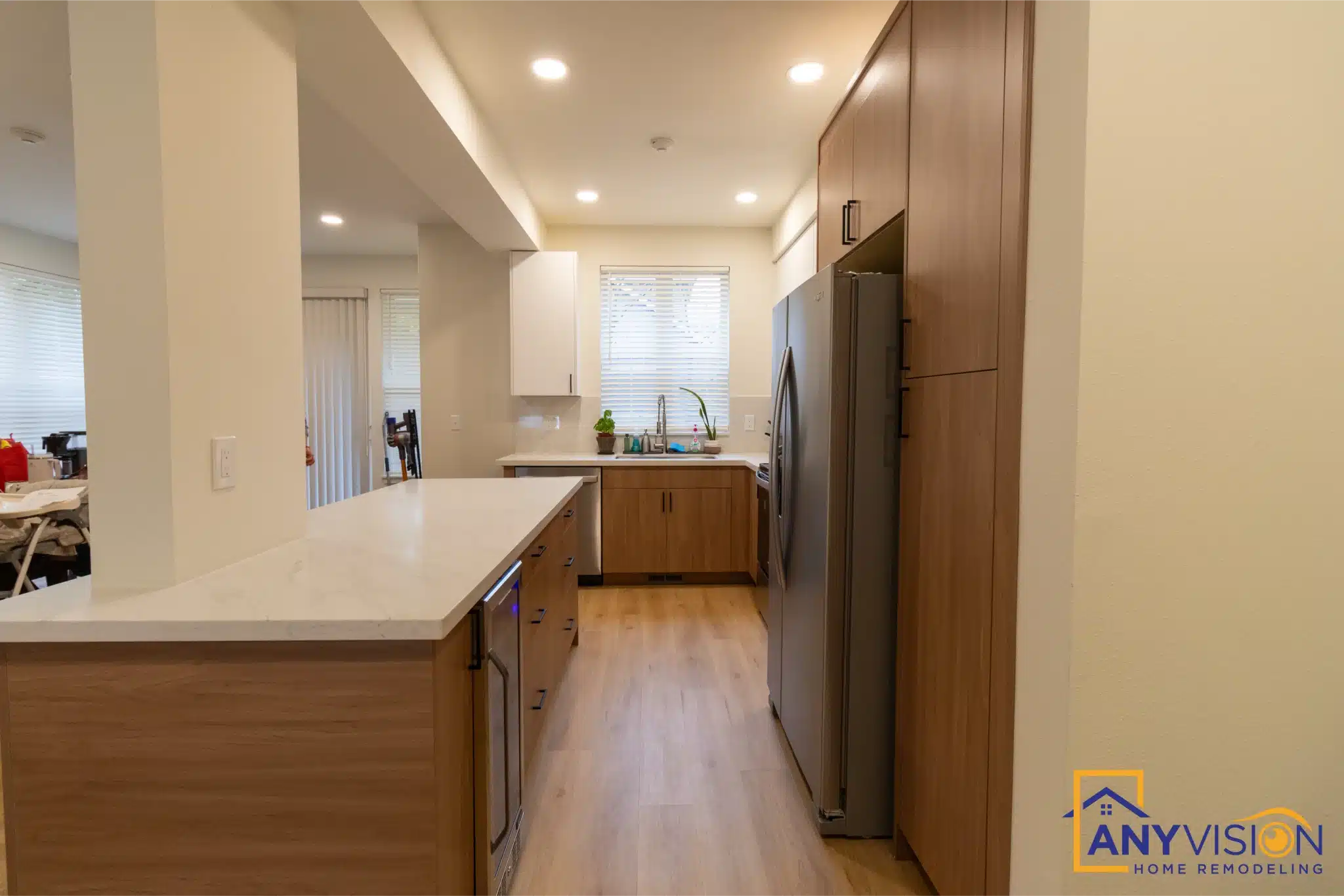 View down the length of the townhome with the kitchen peninsula on the right
