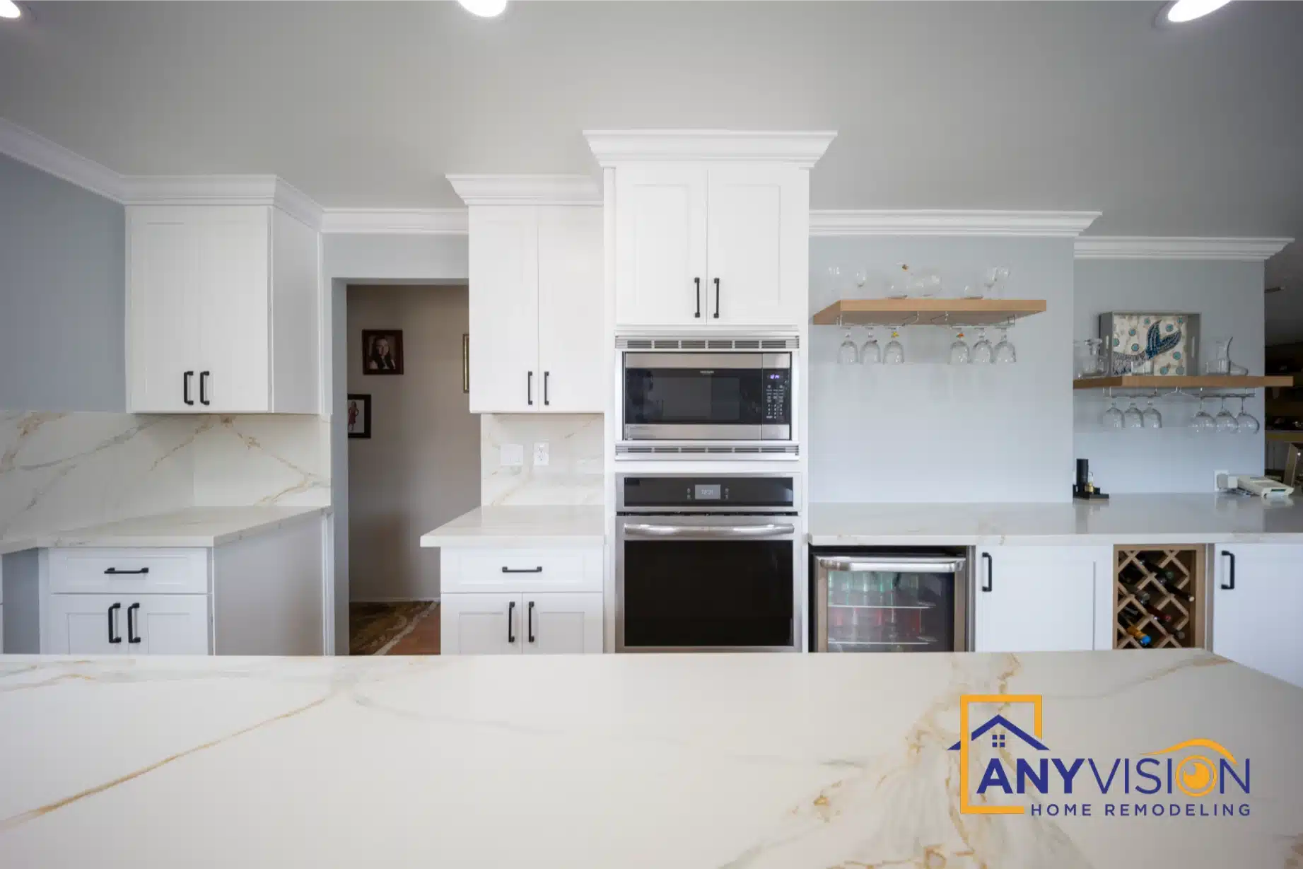 Perimeter run with wall ovens and quartz backsplash