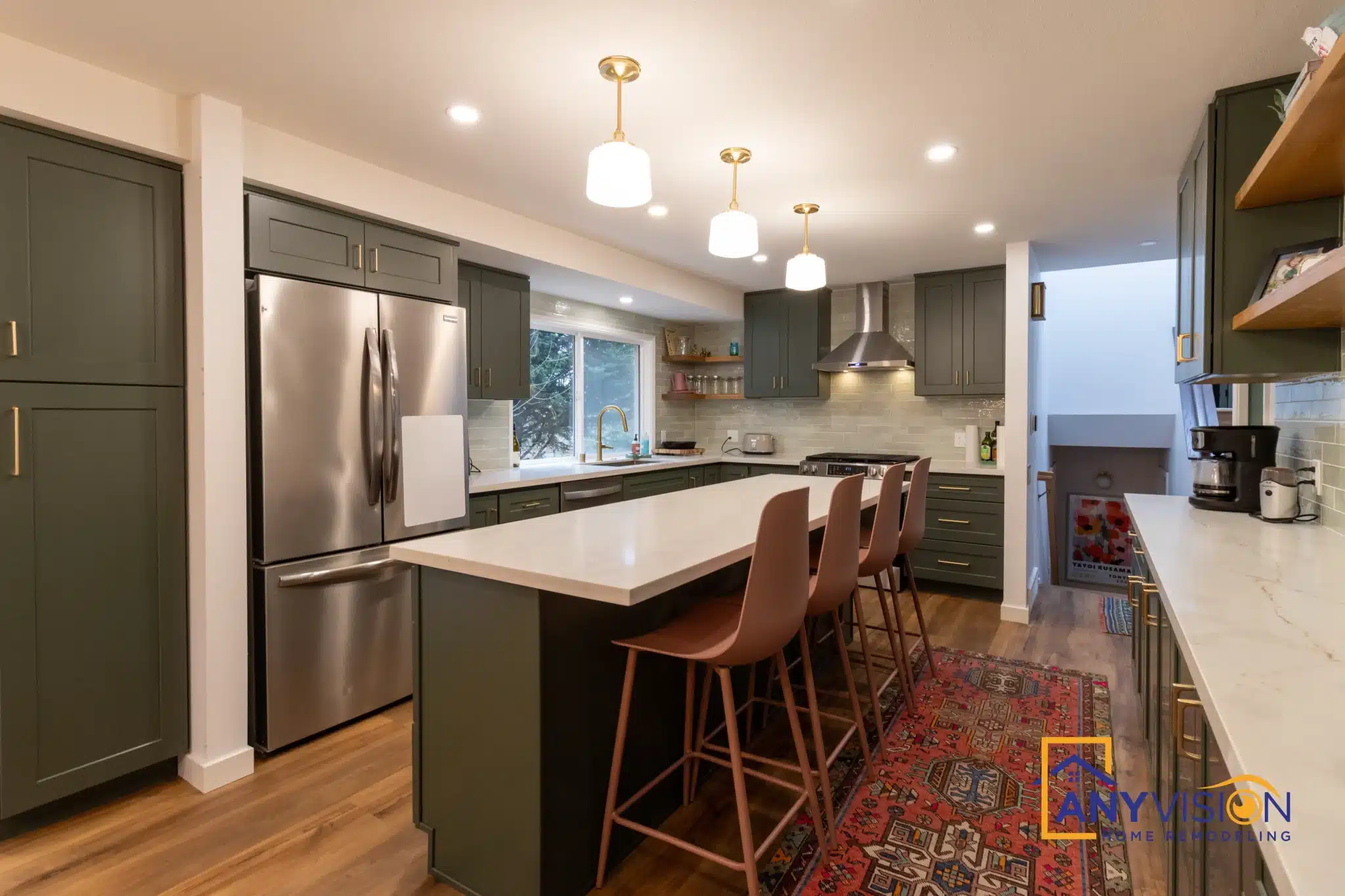 Kitchen seen from the hallway with the refrigerator run and island beyond