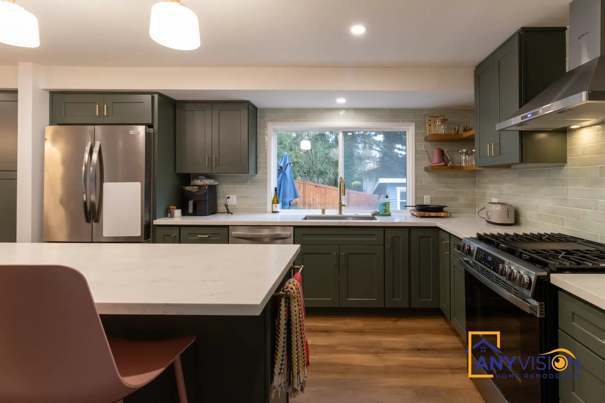 Island with seating on the living-room side and the range wall beyond