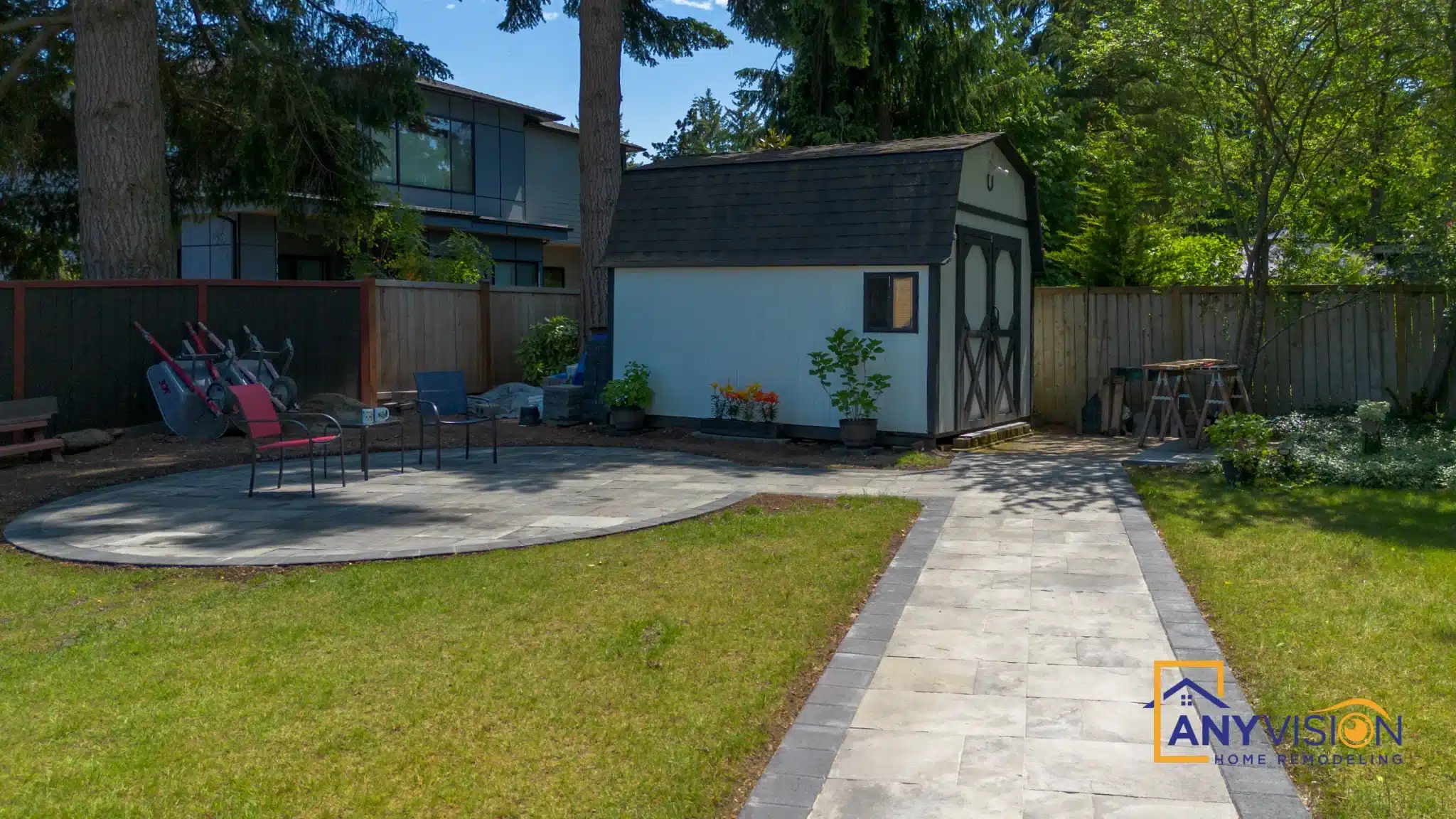 Straight paver walkway running from the house across the lawn to the patio