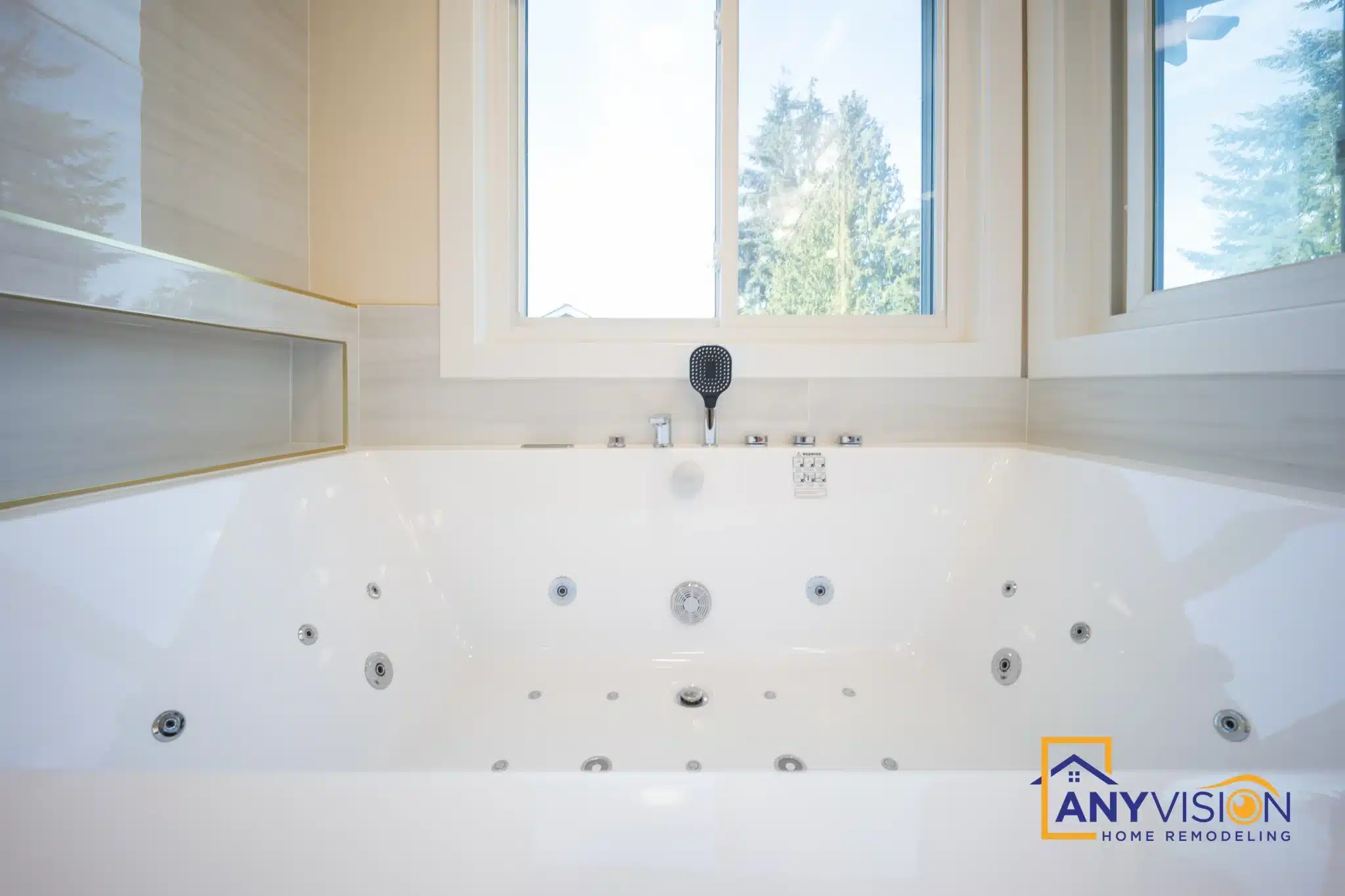 Jetted tub set beneath a window with slab surround