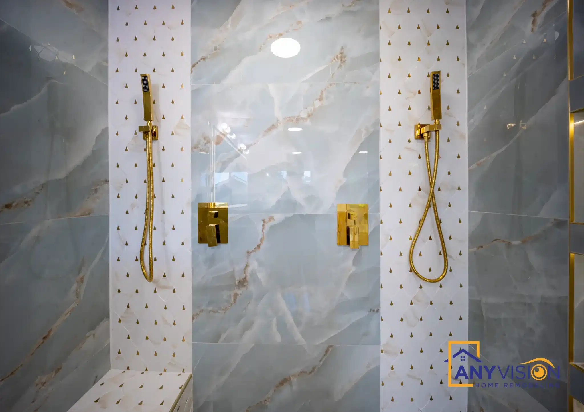 Textured mosaic column set between panels of marble-look slab