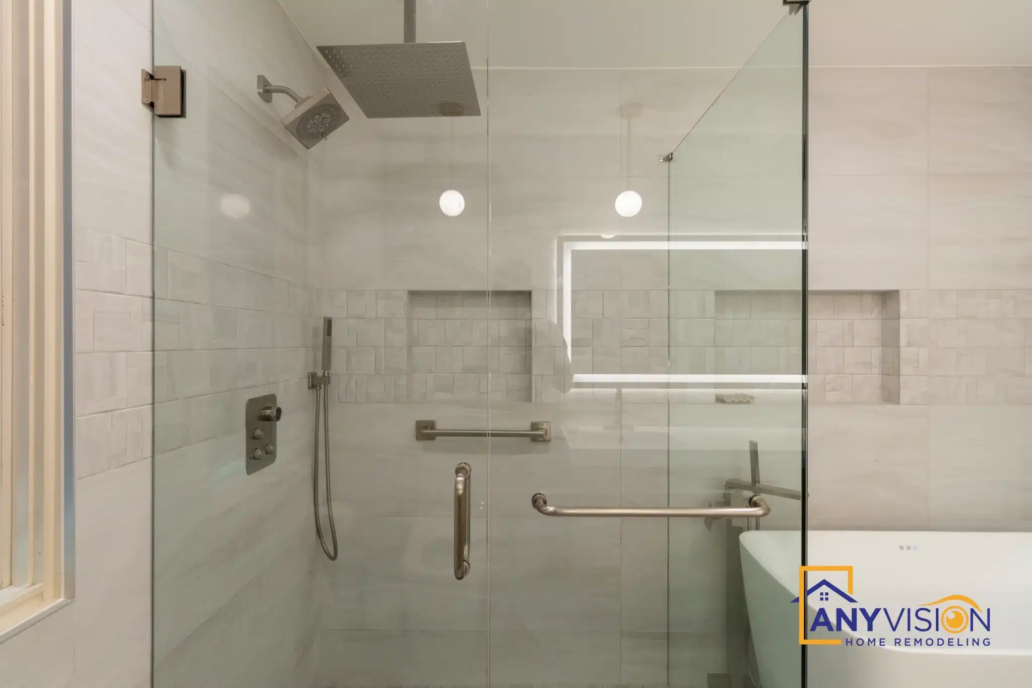 Walk-in shower with frameless glass and large-format wall tile