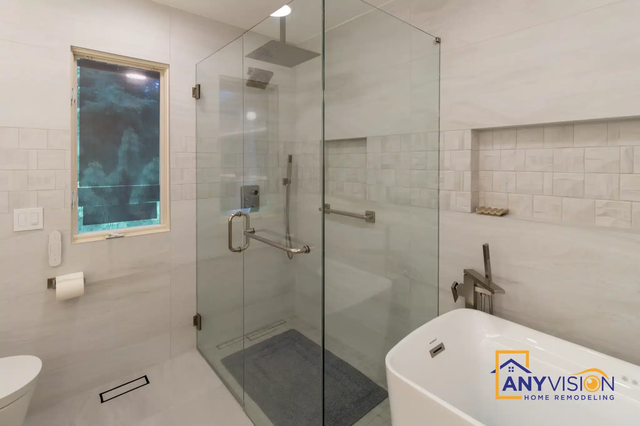 Blue mosaic panel set into the wall beside the shower and tub