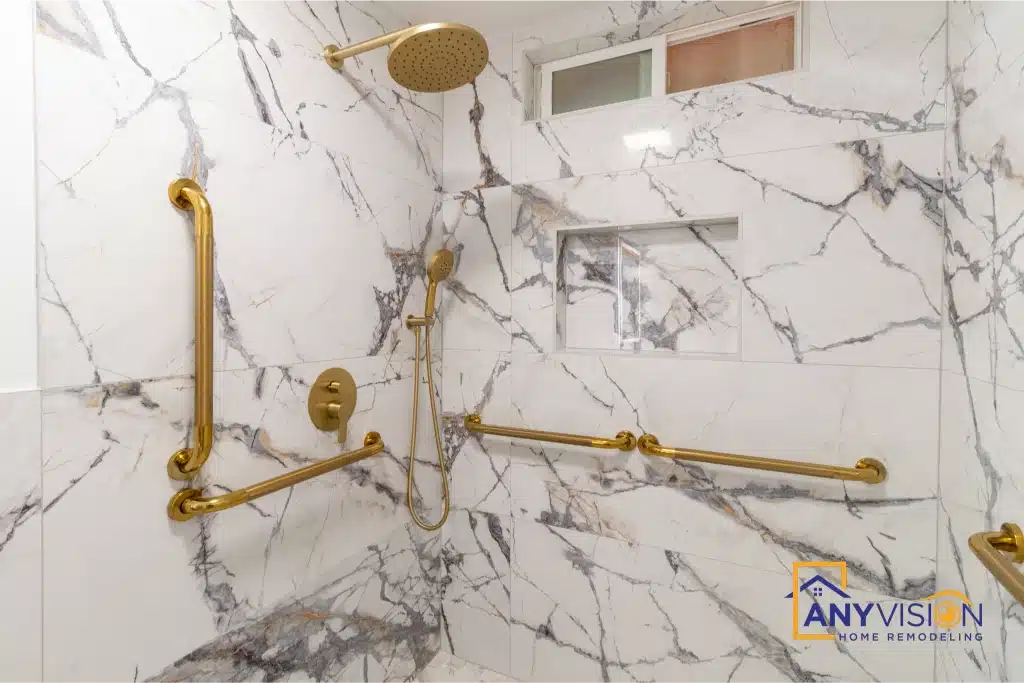 Brass grab bars set horizontally and vertically in the tiled shower