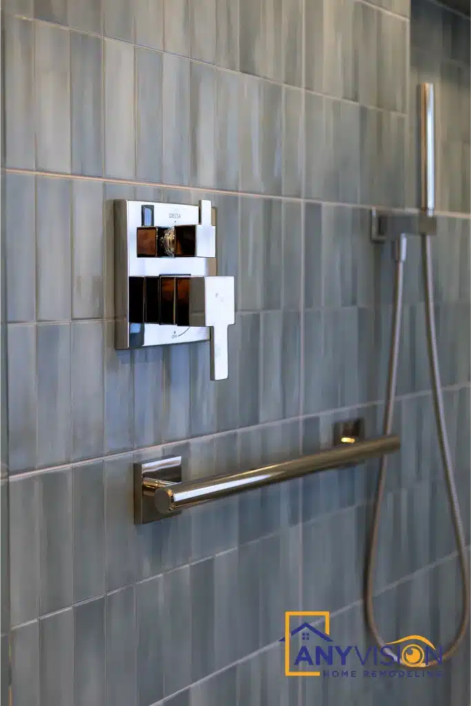 Shower controls with an integrated grab rail on the tiled wall