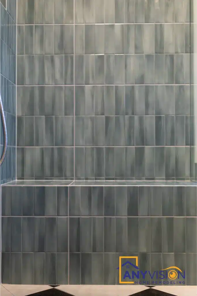 Variegated blue-green tile with visible tonal shift across the wall