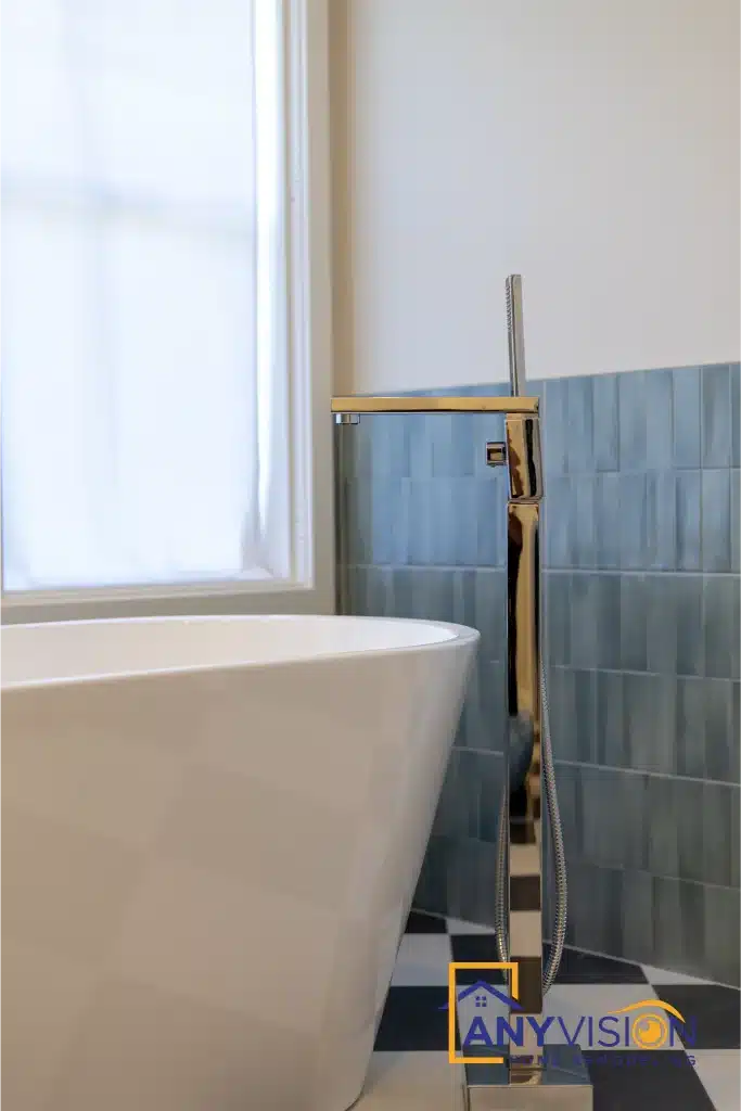 Freestanding tub with floor-mounted filler beneath the window