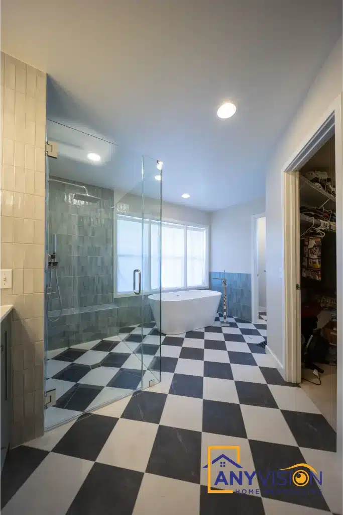 Primary bathroom seen from the doorway, with a freestanding tub and tiled shower beyond