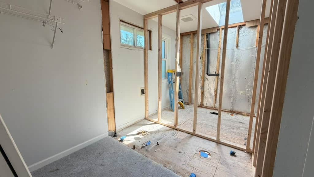Temporary shoring walls installed to support ceiling weight during load-bearing wall removal