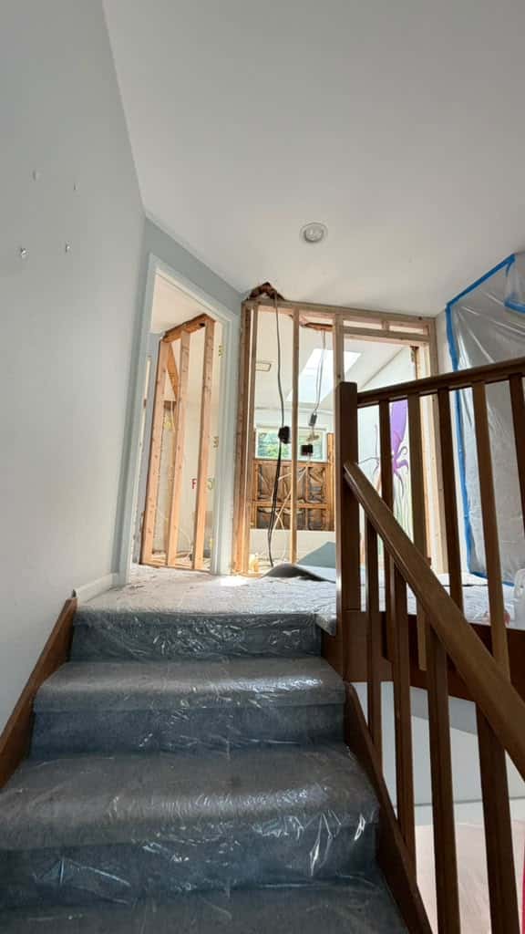 Original split-level staircase protected during structural demolition