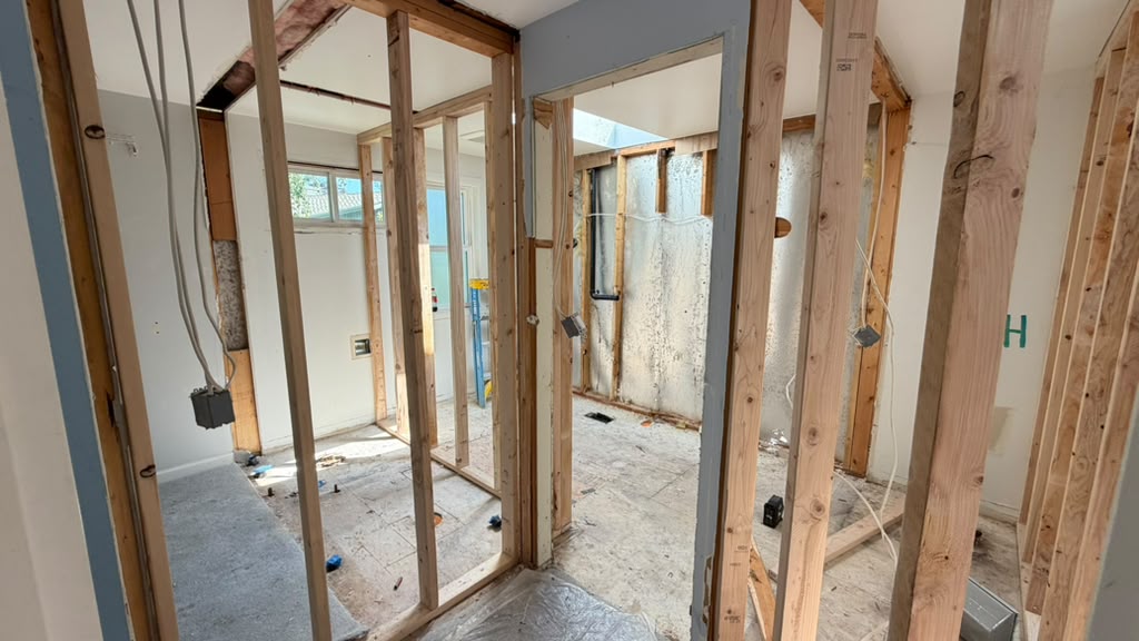 Stud framing and ceiling joists showing the load path in a Redmond split-level remodel