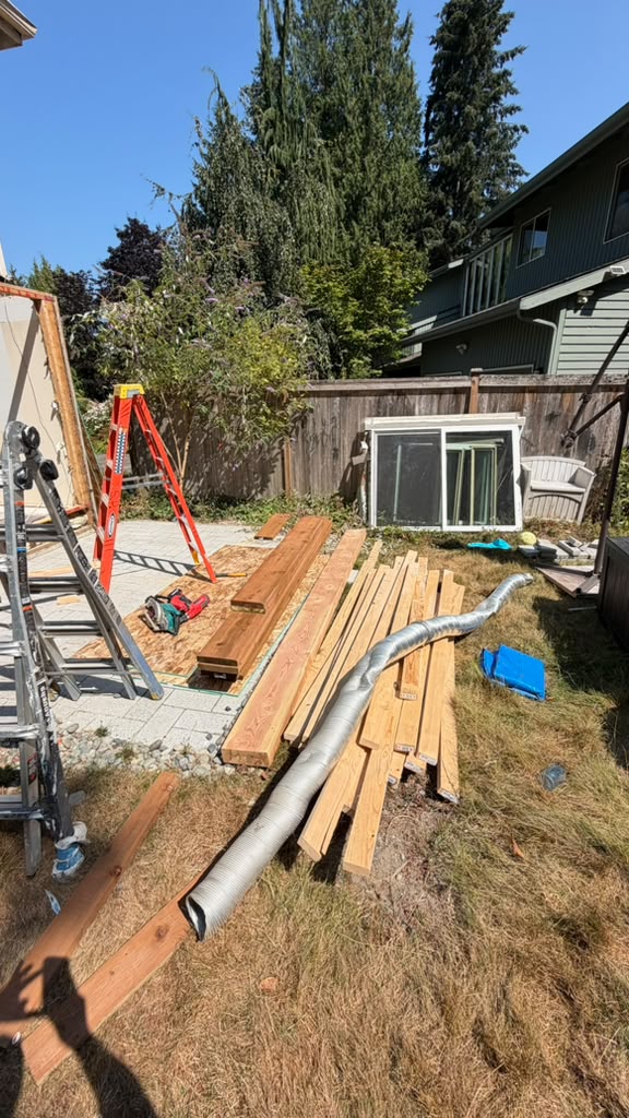 Framing lumber staged outside a Redmond split-level addition
