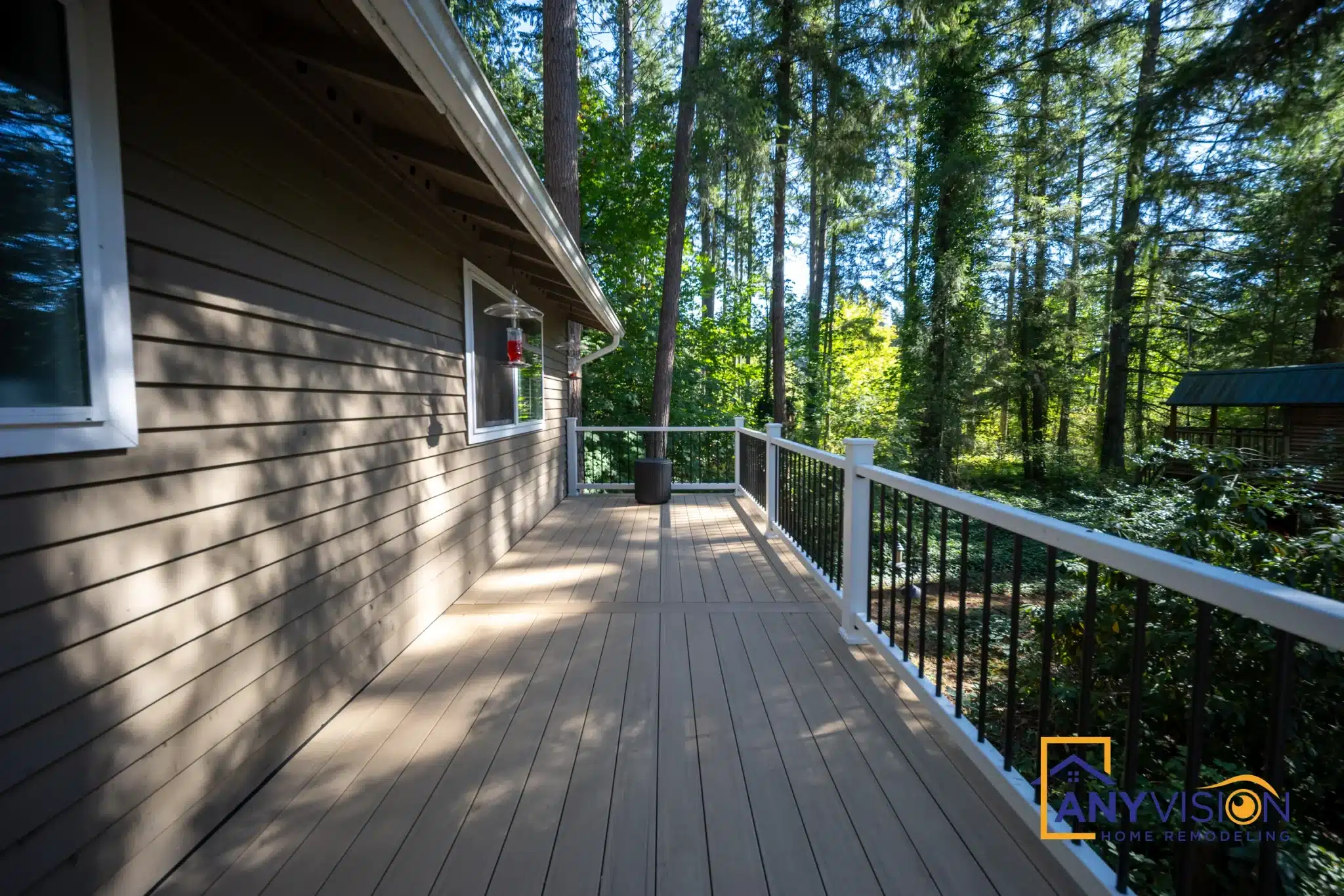 Deck boards and railing running toward the corner of the house