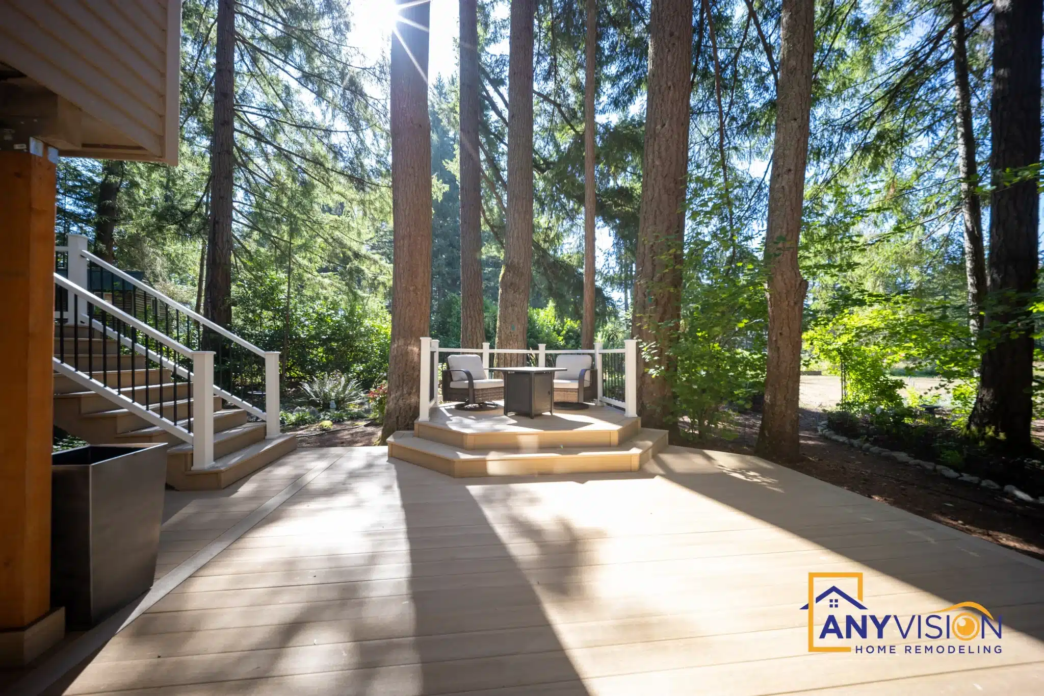 Multi-level deck under mature evergreens on a sloping Redmond lot