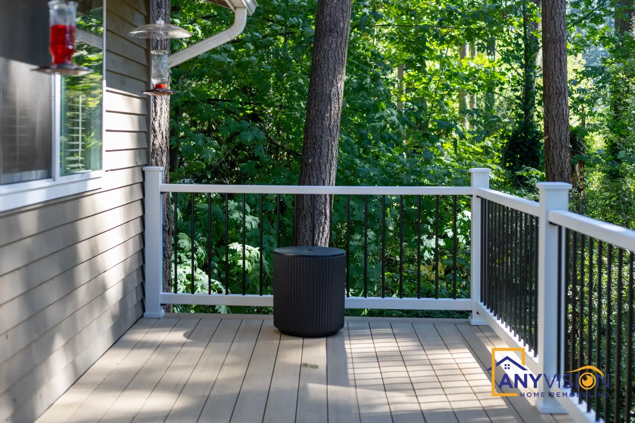 Corner of the deck with railing framing the wooded outlook