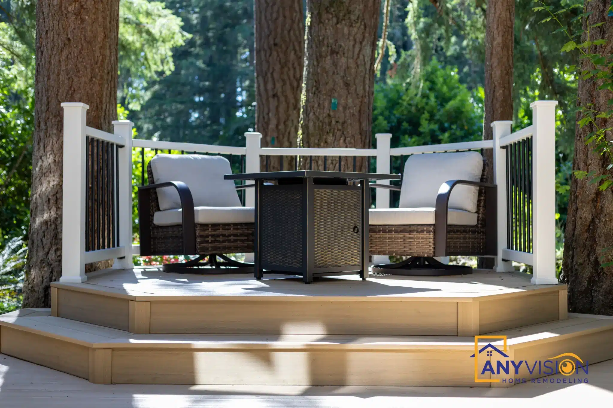 Seating and fire table on the finished deck under the evergreens
