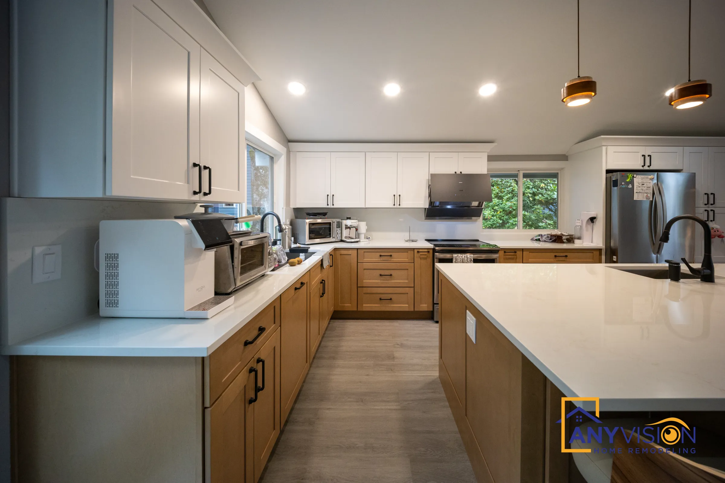 White shaker uppers over wood-tone lower cabinets along the perimeter