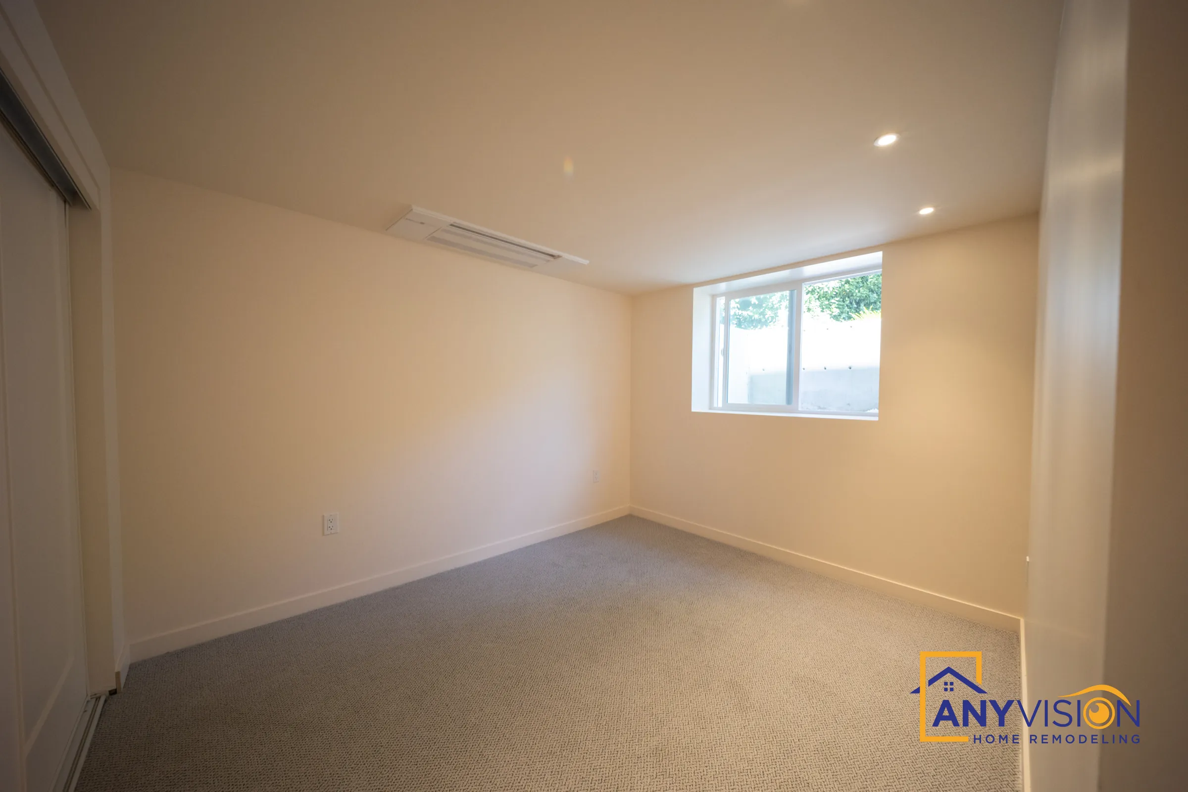 Basement bedroom with a daylight window and neutral carpet