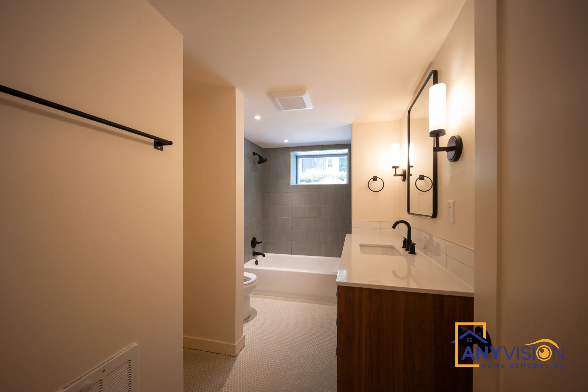View into the bathroom past the towel bar and vanity