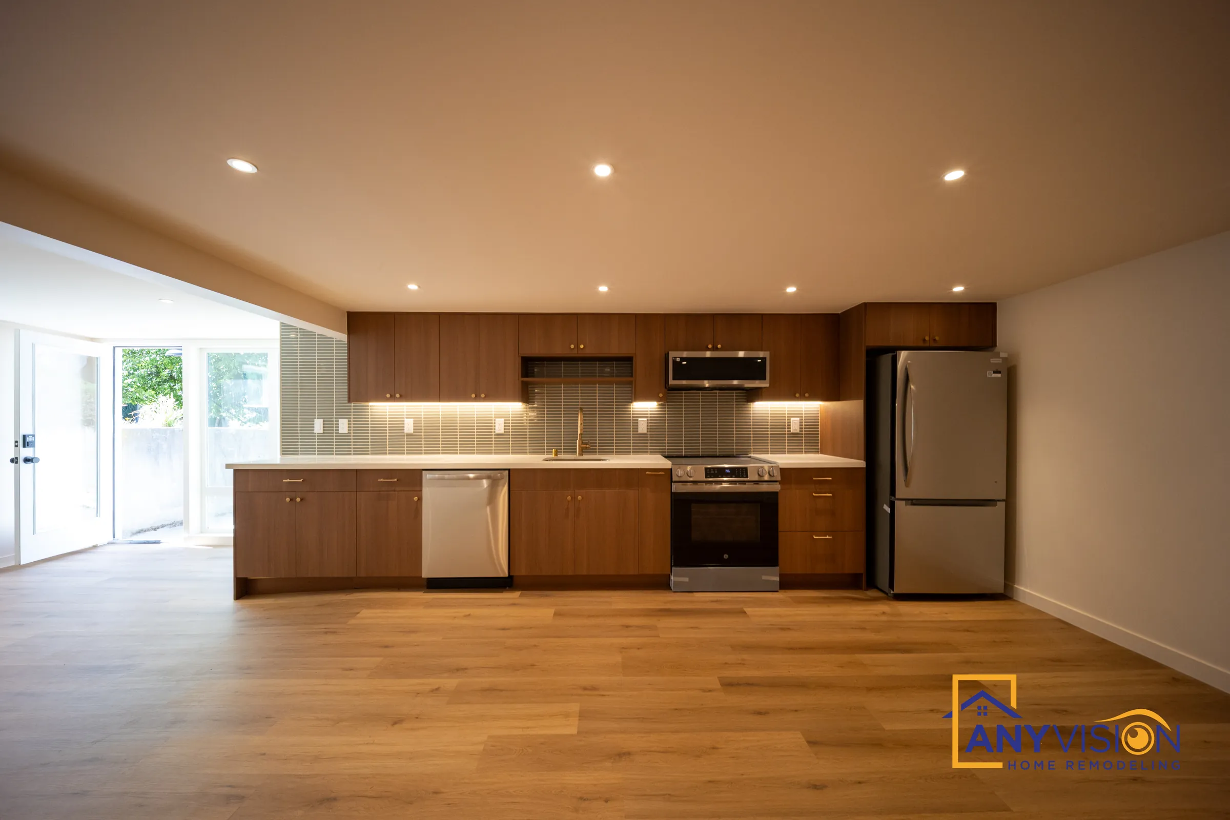 Finished basement with a full kitchen and wood-look flooring in Northwest Seattle, built by Anyvision